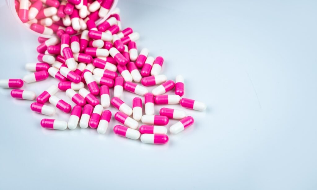 Pharmaceutical capsules in pink and white colors – Senu Consult
